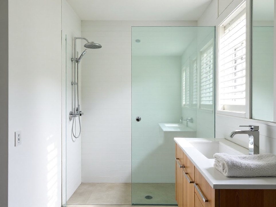 A finished family bathroom with a frameless glass shower in a renovated Queenslander